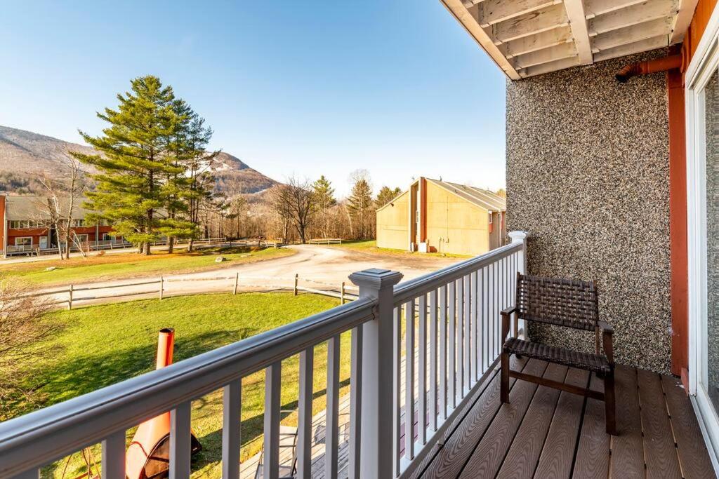 a wooden porch with a bench on a balcony at Hunter Mountain Ski House - A Cozy Retreat by the Slopes in Hunter