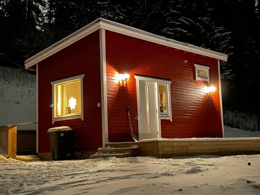 オーレにあるSolbergs, fint attefallshus i Vik, Åreの雪面の窓が2つある小さな赤い家