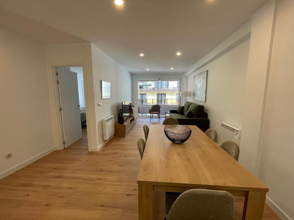 a living room with a wooden table and a dining room at IZARRA by Smiling Rentals in Hondarribia