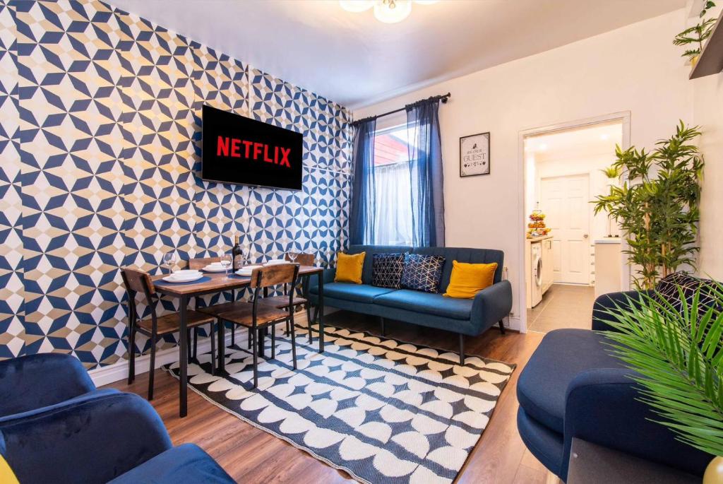 a living room with a blue and white patterned wall at Kingsway House in Coventry