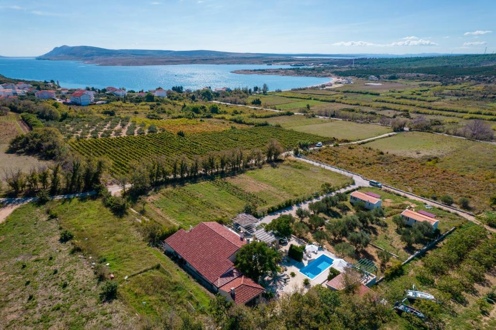 an aerial view of a farm and a lake at Family friendly house with a swimming pool Caska, Pag - 20734 in Novalja