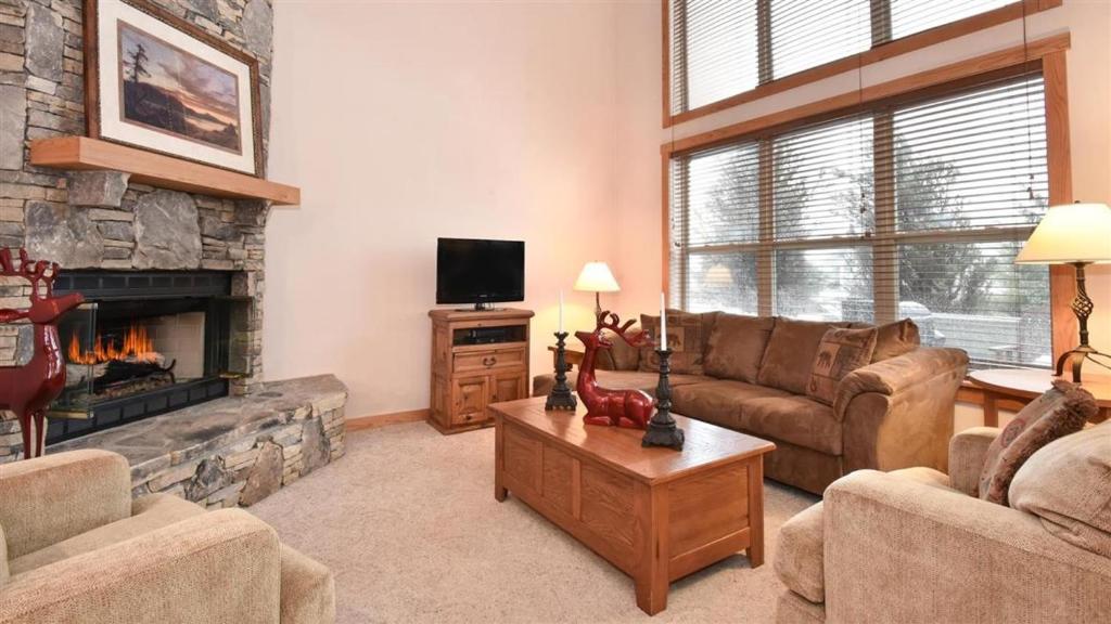 a living room with a couch and a fireplace at Seven Springs Woodridge 3 Bedroom Premium Condo, Sleeps 7! condo in Champion