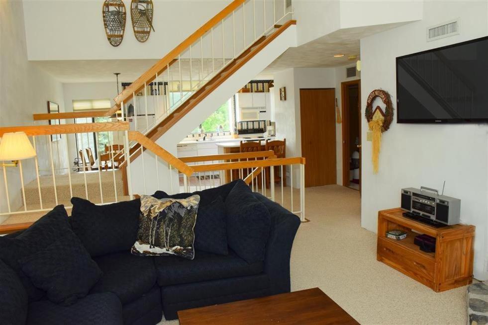 a living room with a blue couch and a tv at Seven Springs Meadowridge 2 Bedroom Standard Condo, Mountain Views! condo in Champion