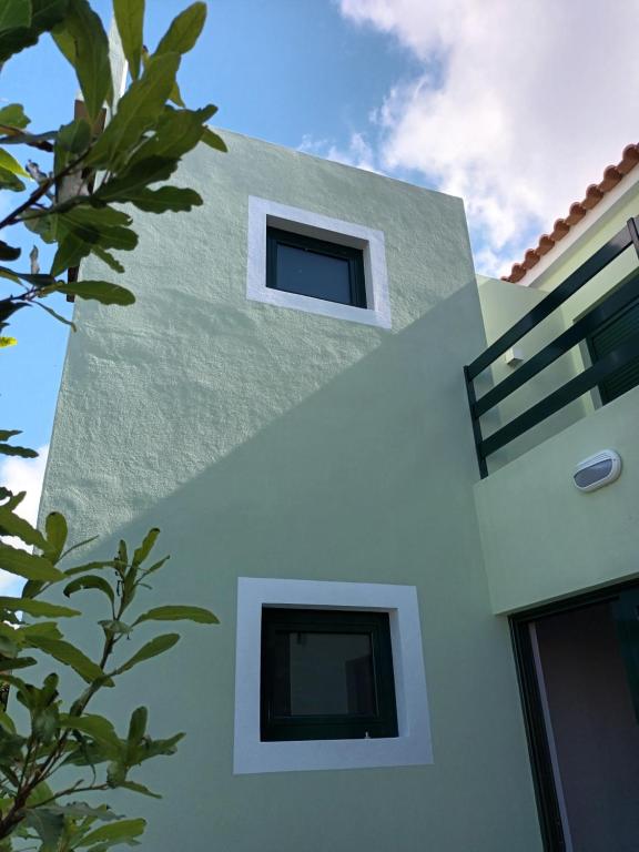 a white house with two windows on the side of it at Casa do Lameirinho in Angra do Heroísmo