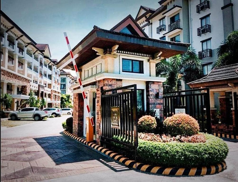 a house with a gate in front of a building at One Oasis Condominium in Davao City