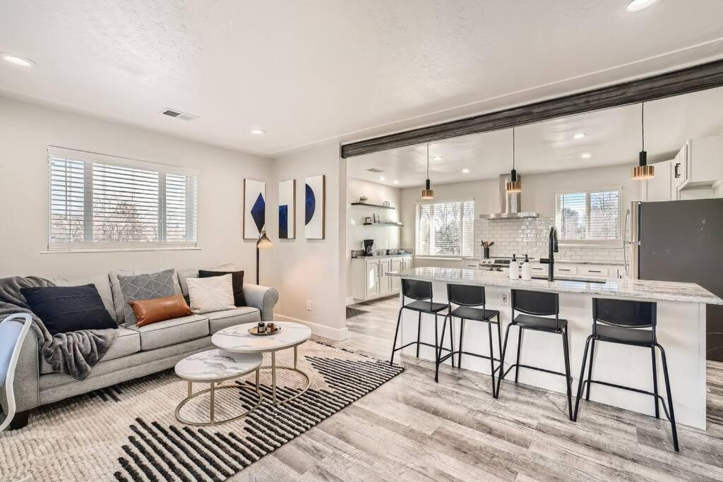 a living room with a couch and a kitchen at NEW Luxurious Modern Space just West of Denver in Wheat Ridge