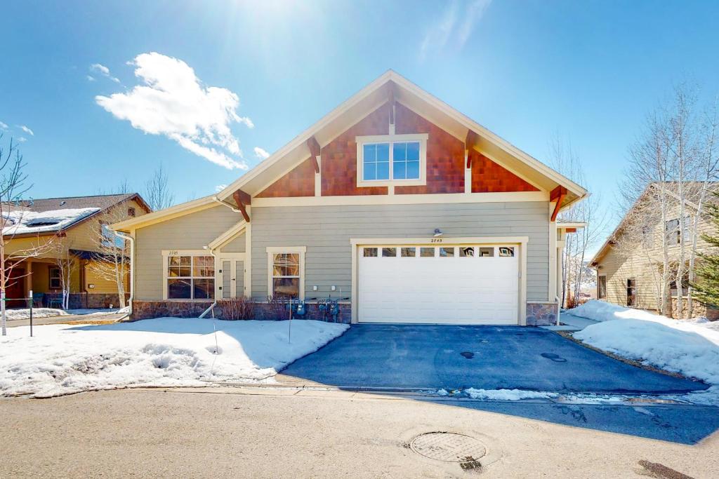 a house with a garage in the snow at The Aerie of Eagle in Eagle