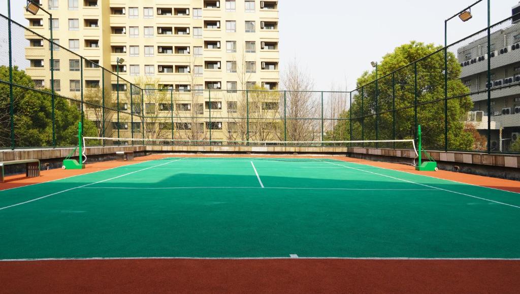 a tennis court in front of a building at Belgravia Serviced Residence Wuxi in Wuxi