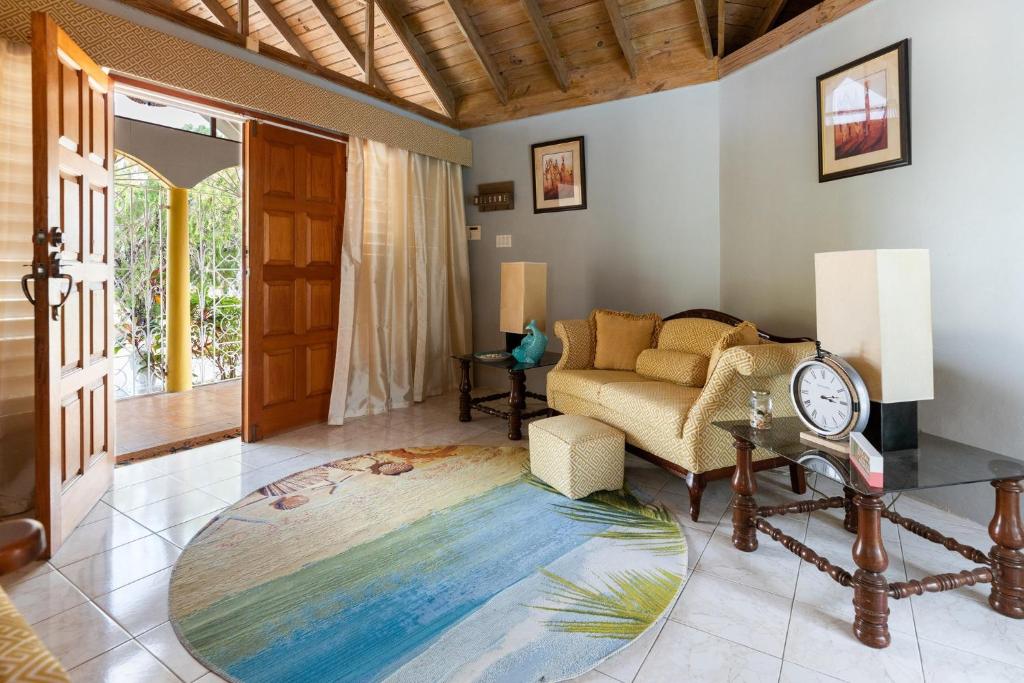 a living room with a couch and a table at Yancey Largo Villa with Private Pool in Montego Bay