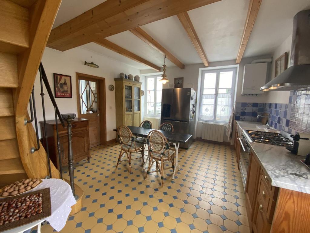 a kitchen with a table and chairs in a room at Maison Fouras, 6 pièces, 8 personnes - FR-1-709-39 in Fouras