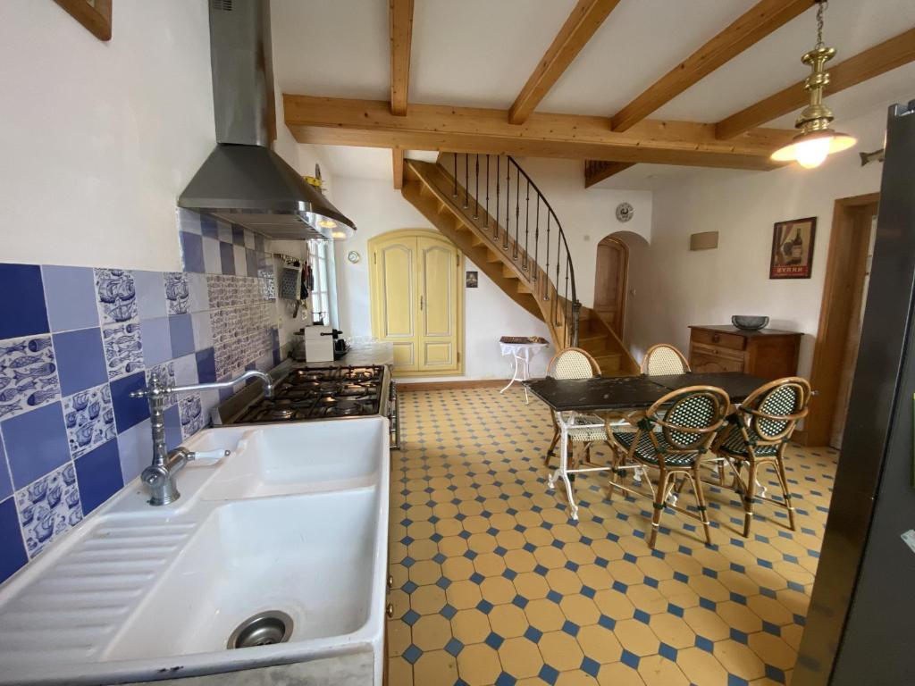 a kitchen with a sink and a table at Maison Fouras, 6 pièces, 8 personnes - FR-1-709-39 in Fouras