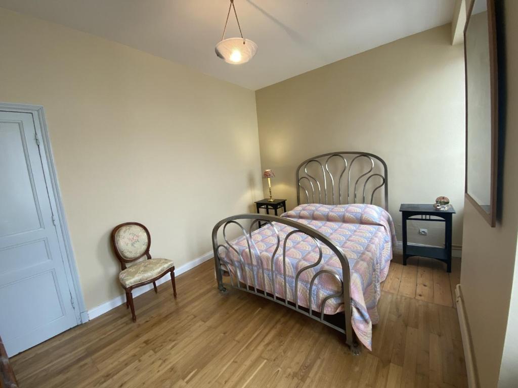 a bedroom with a bed and a chair at Maison Fouras, 6 pièces, 8 personnes - FR-1-709-39 in Fouras