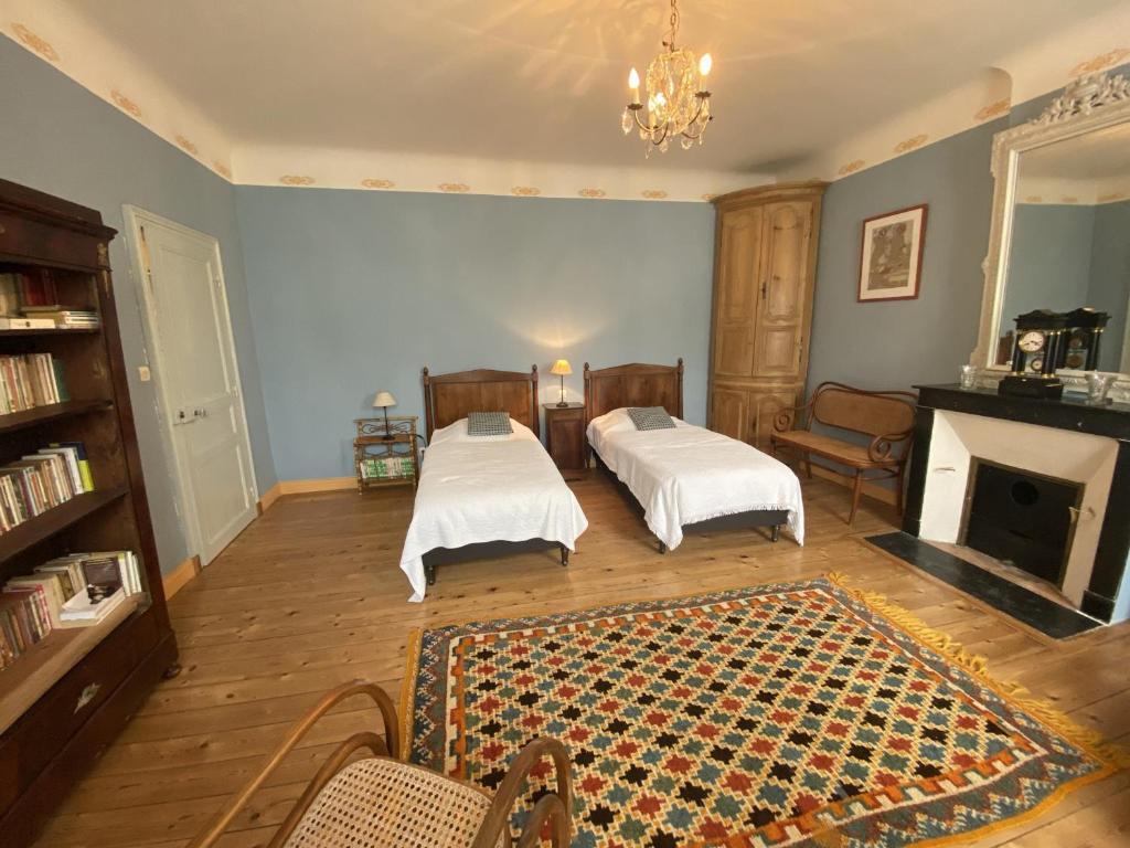 a living room with two beds and a fireplace at Maison Fouras, 6 pièces, 8 personnes - FR-1-709-39 in Fouras