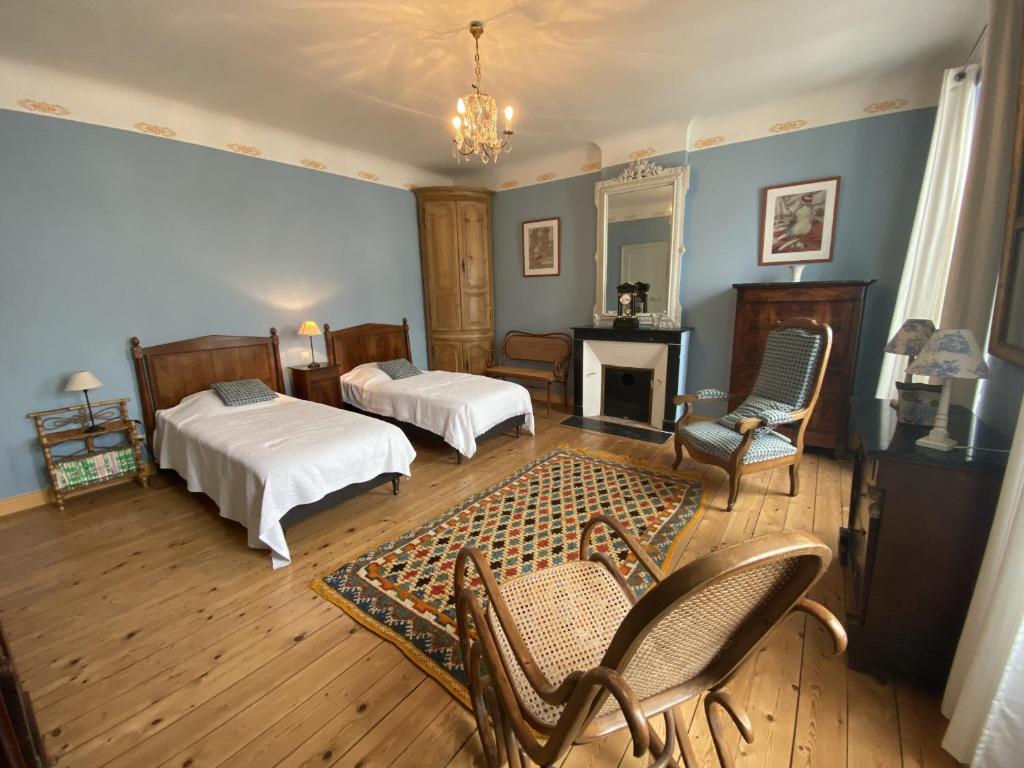 a bedroom with two beds and a fireplace at Maison Fouras, 6 pièces, 8 personnes - FR-1-709-39 in Fouras