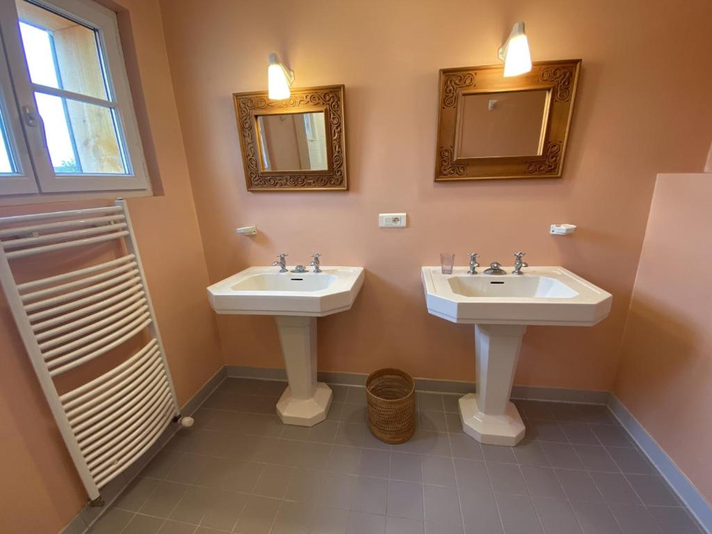 a bathroom with two sinks and two mirrors at Maison Fouras, 6 pièces, 8 personnes - FR-1-709-39 in Fouras