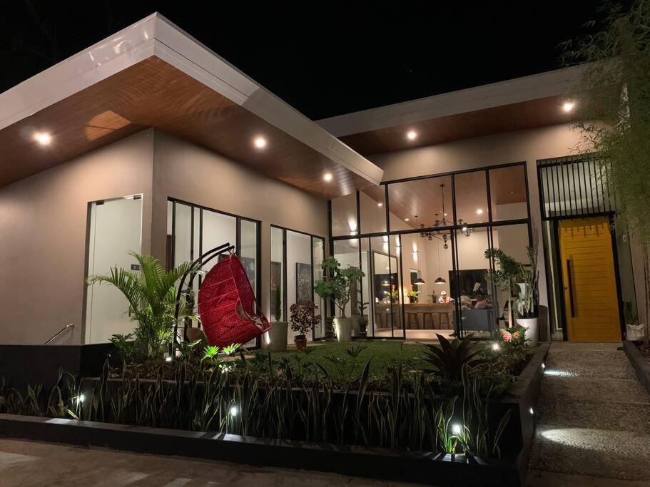 ein Haus mit vielen Fenstern und Pflanzen in der Unterkunft The Great Molave SUPERIOR ROOM in Cavite