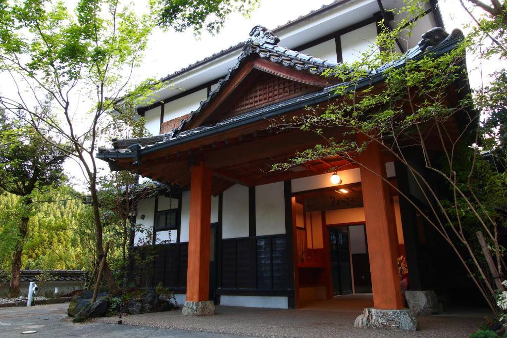 an asian style building with orange columns at YamakawaZENZO in Oguni