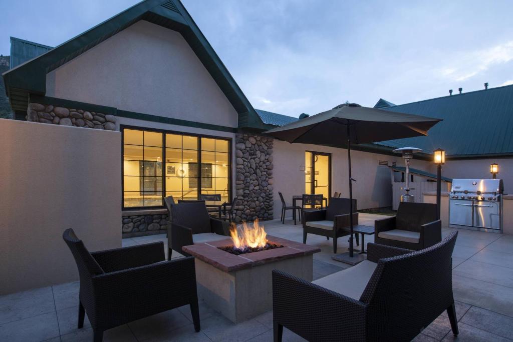 a patio with a fire pit and tables and chairs at Residence Inn Durango Downtown in Durango