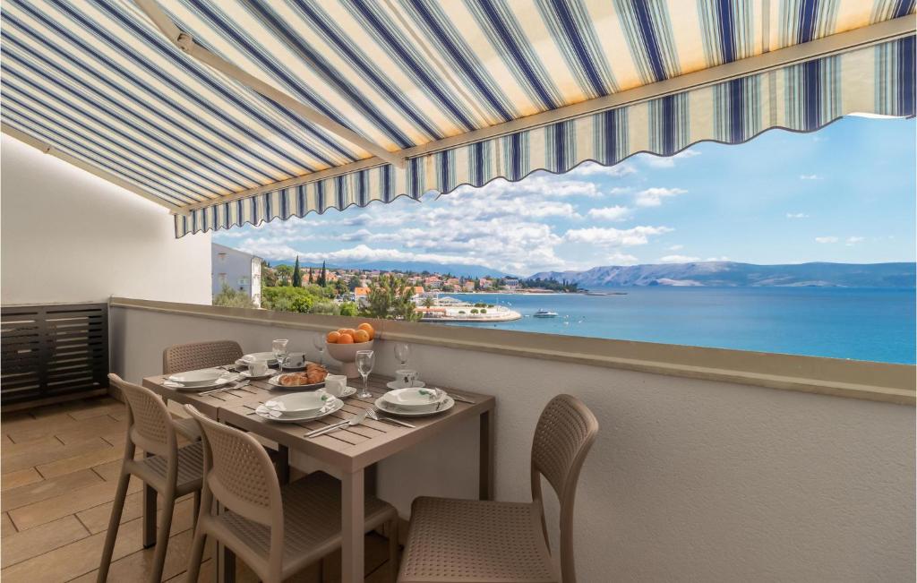 a dining room with a table and a view of the water at Amazing Apartment In Selce With House Sea View in Selce