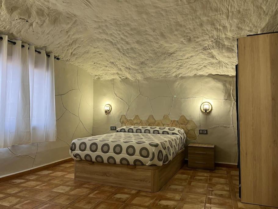 1 dormitorio con 1 cama grande en una habitación en Casa Cueva en Entorno Tranquilo., en Murcia