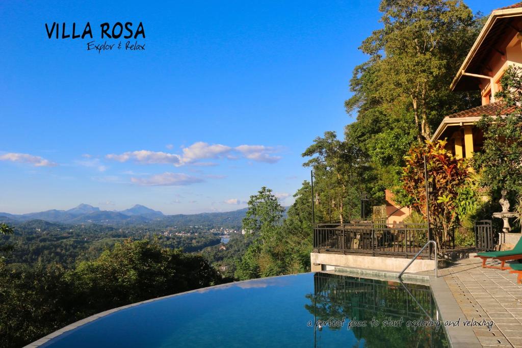 a swimming pool with a view of the mountains at Villa Rosa in Kandy