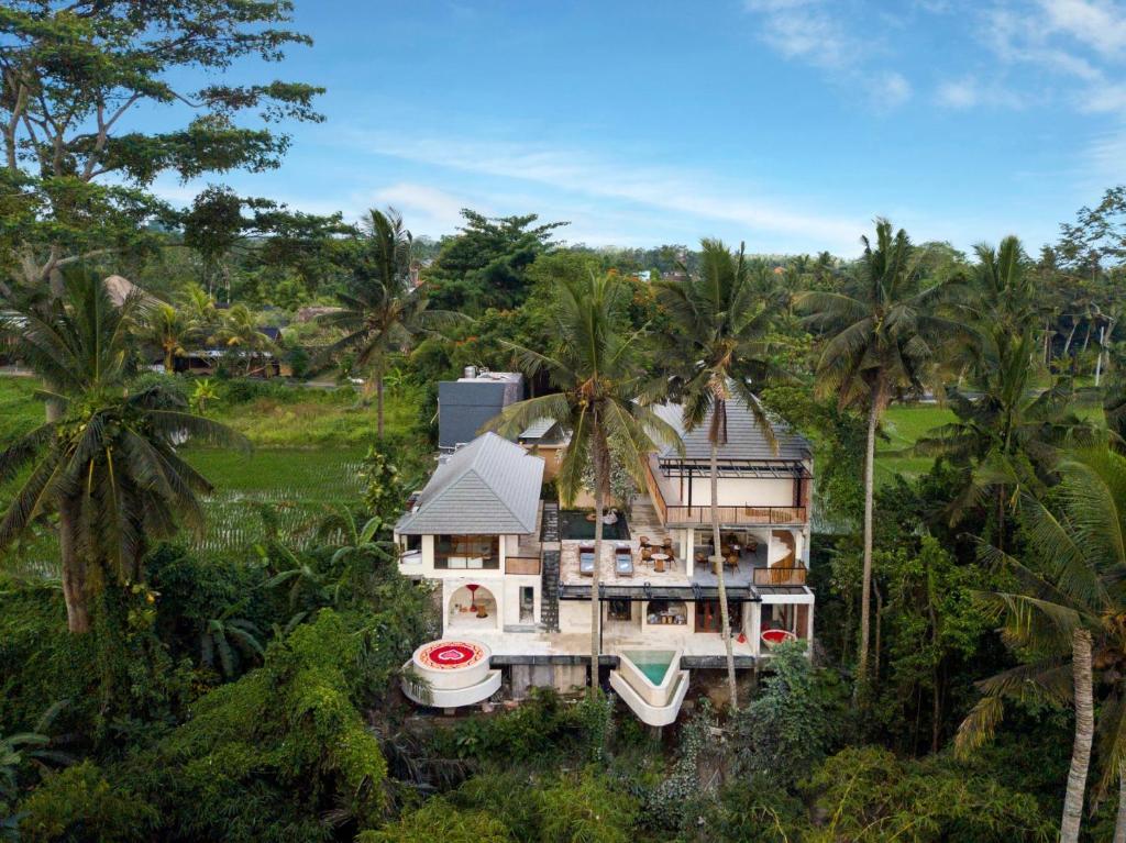 an aerial view of a house with palm trees at Suara Alam Hotel Ubud by Ini Vie Hospitality in Ubud