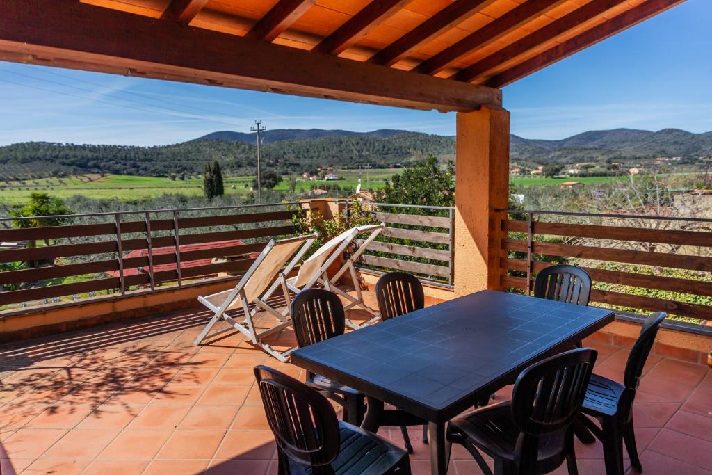 a table and chairs on a patio with a view at Casa Rita in Castiglione della Pescaia