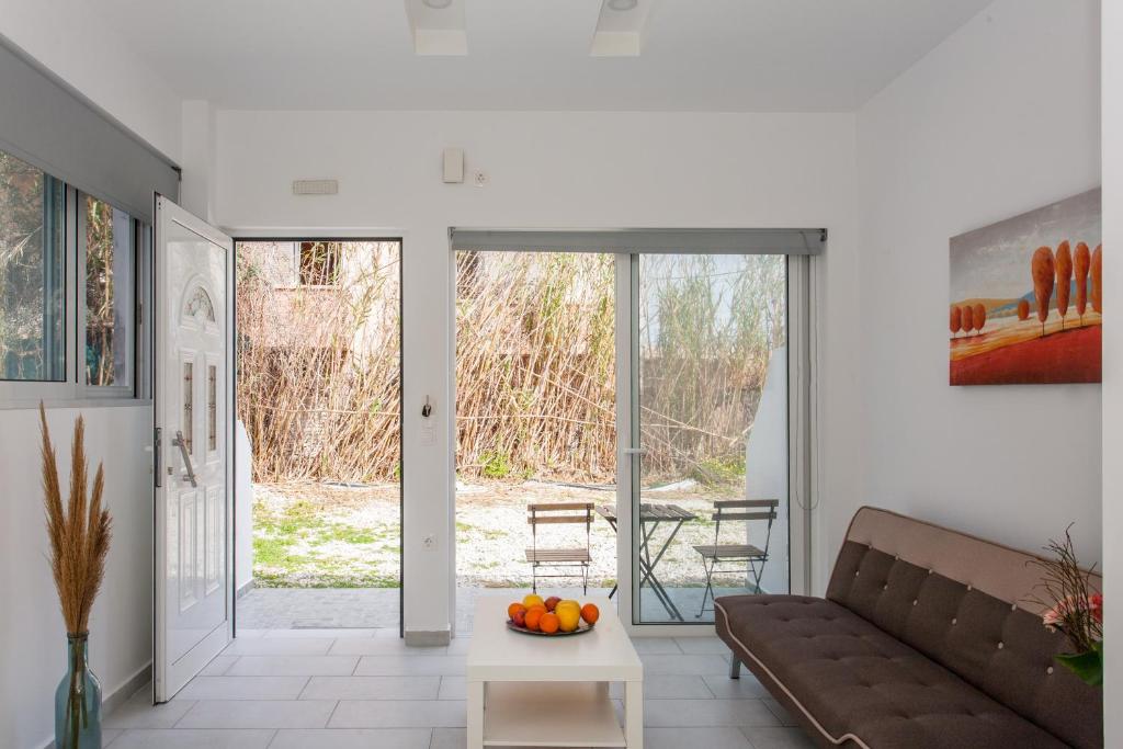 a living room with a couch and a table at Glaros Studios in Kalamaki Chanion