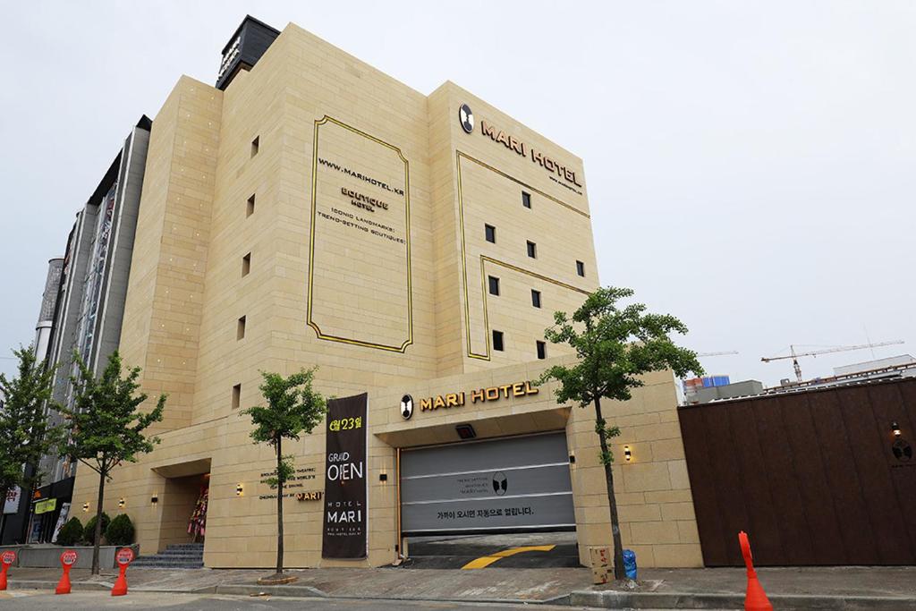 a large building with a sign on the front of it at Mari Hotel in Cheongju