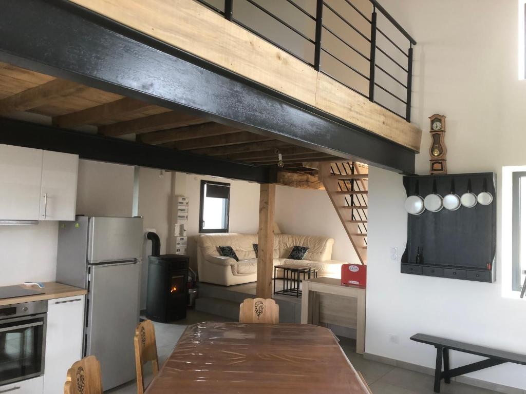 a kitchen with a table and a dining room at Ancienne ferme rénovée 