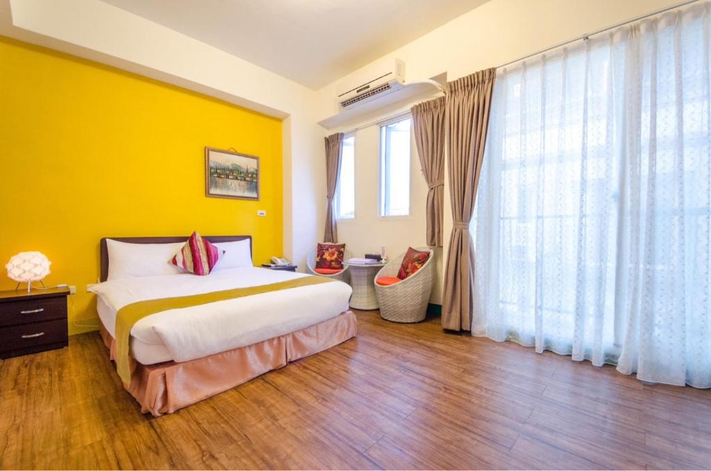 Postel nebo postele na pokoji v ubytování Sweet B&B 幸福微甜民宿