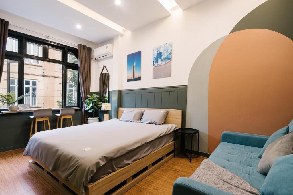 a bedroom with a bed and a couch at KemKayVilla w 5BR_ Bathtub_RooftopViews_30s to HoanKiem Lake in Hanoi