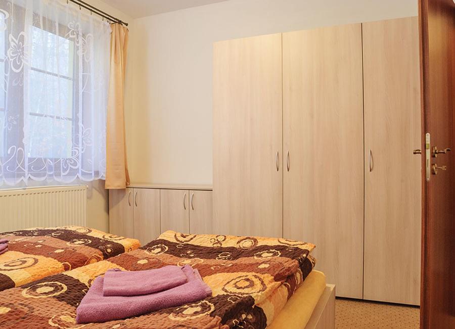 Postel nebo postele na pokoji v ubytování Apartmány Řezáč