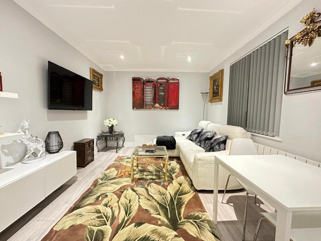 a living room with a couch and a table at Stylish Central London Apartment in London