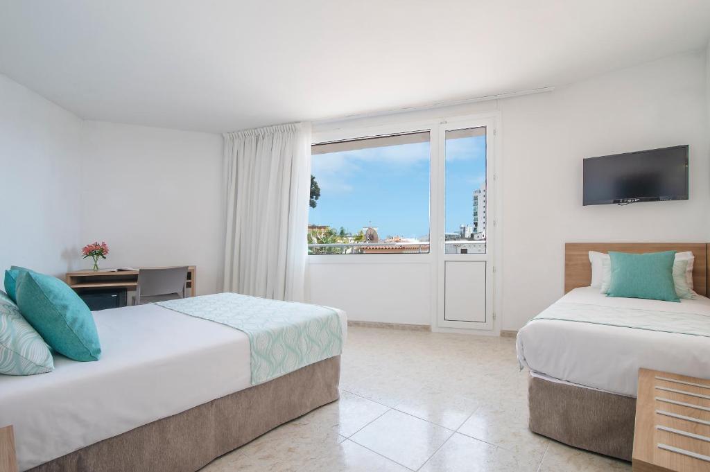 Ліжко або ліжка в номері Hotel Lloret Santa Rosa by Pierre & Vacances