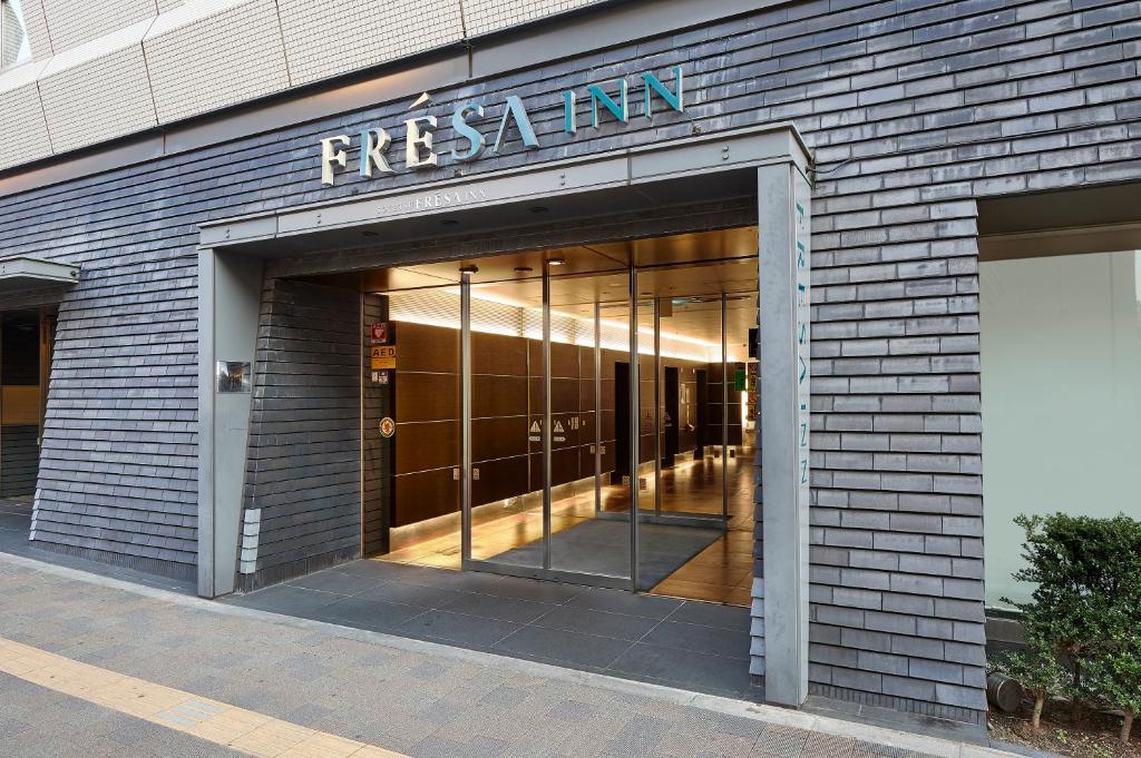 an entrance to a building with a sign on it at Sotetsu Fresa Inn Higashi Shinjuku in Tokyo