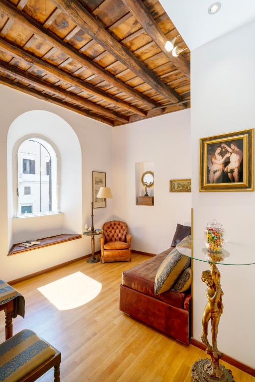 a living room with a couch and a glass table at Pantheon Caravaggio's House in Rome