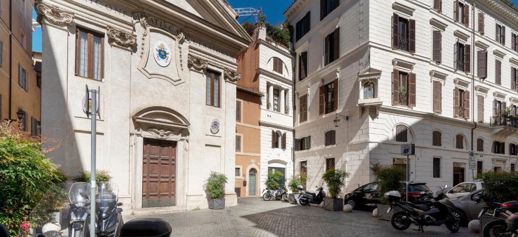 a city street with buildings and cars parked on the street at Pantheon Caravaggio's House in Rome