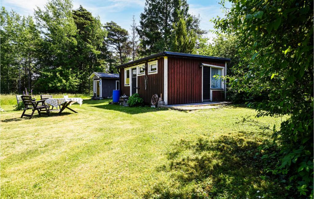 a small shed with a picnic table in a yard at Amazing Home In Slite With 2 Bedrooms in Slite