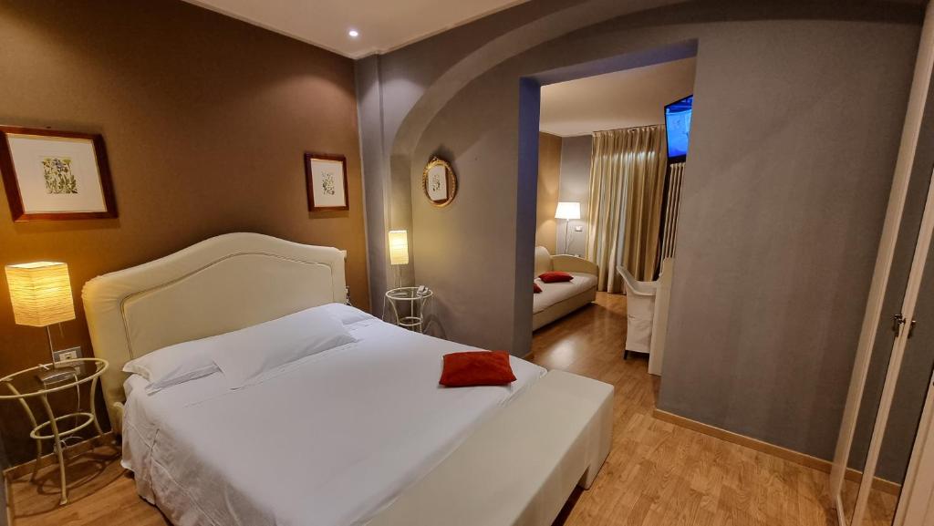 Ένα ή περισσότερα κρεβάτια σε δωμάτιο στο Albergo Trieste