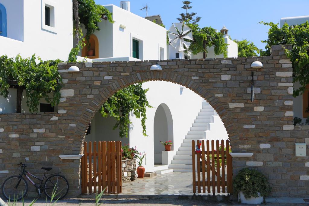 an archway in front of a building with a bike at Eleni Dream Village in Parikia