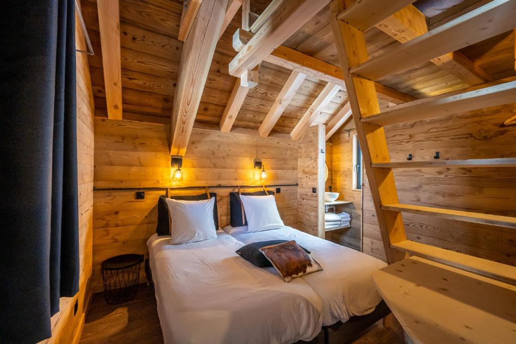 Postel nebo postele na pokoji v ubytování Les chalets d'Éléna