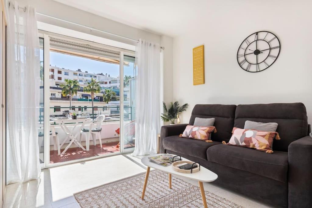 a living room with a couch and a large window at Plage, Lumineux, Ensoleillée in Antibes