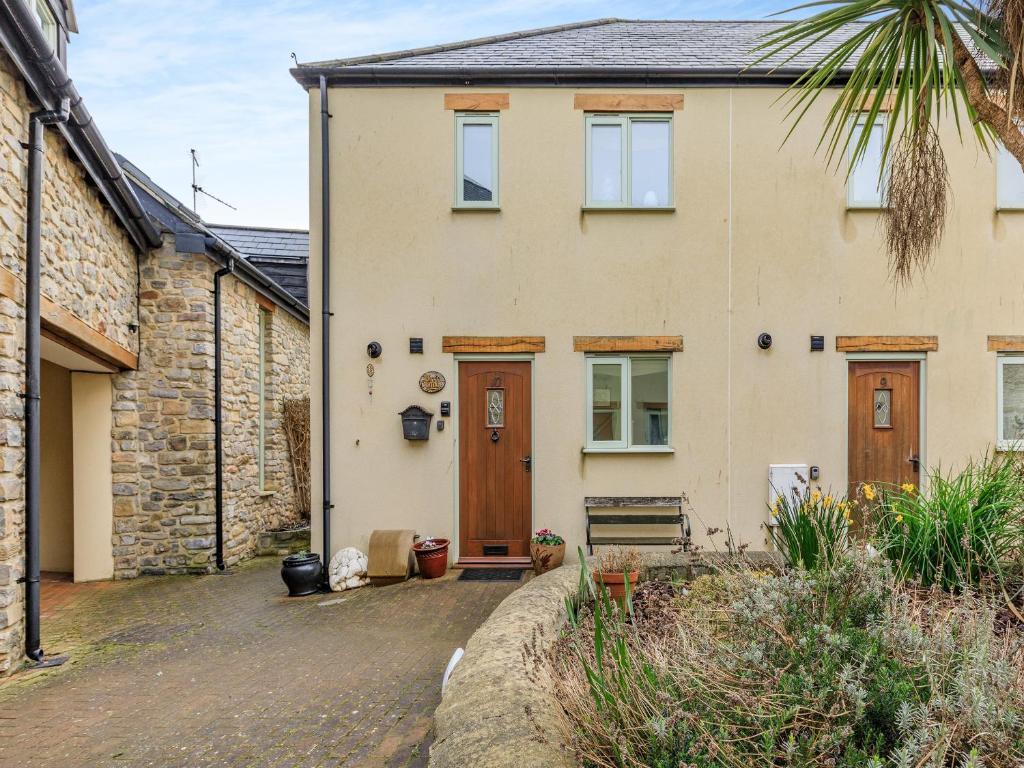 a house with a driveway in front of it at Birch Cottage in Watchet