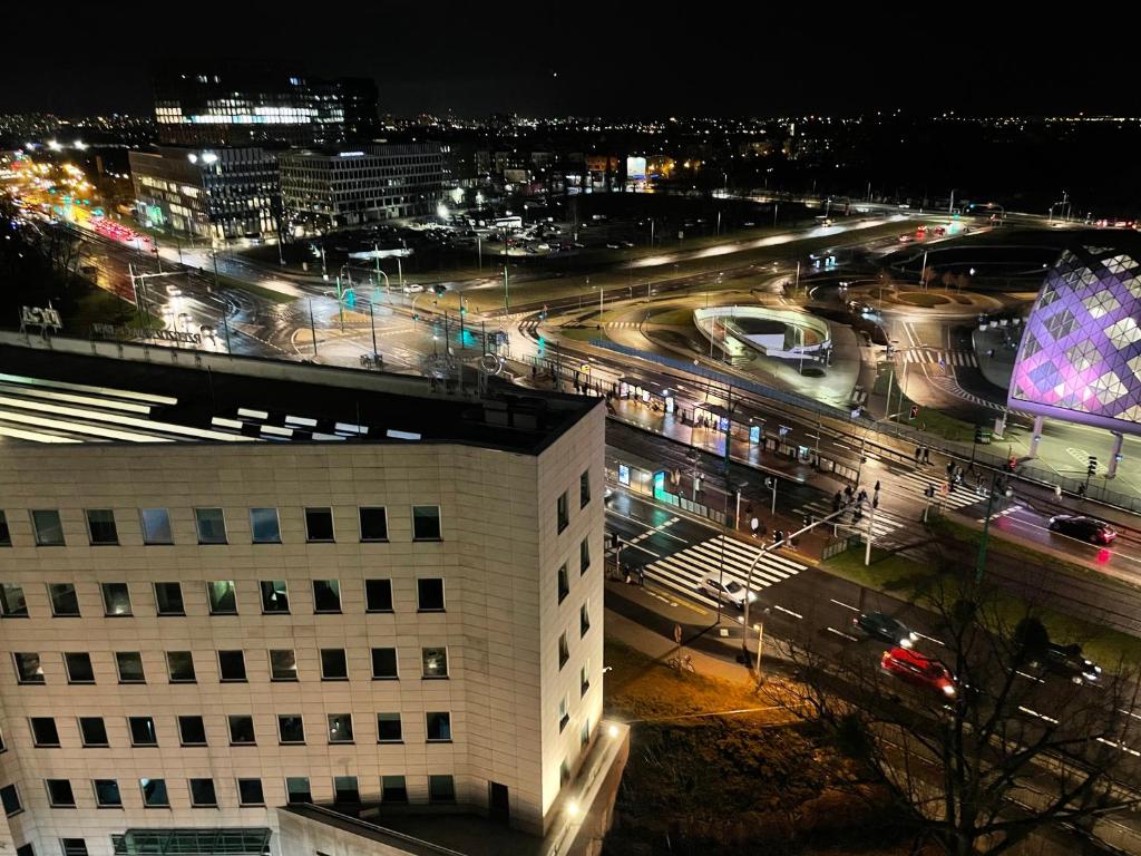 a view of a city at night with traffic at Towarowa Milionowa 39 in Poznań