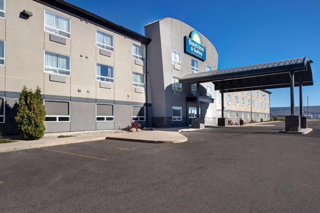 an empty parking lot in front of a hotel at Days Inn & Suites by Wyndham Yorkton in Yorkton