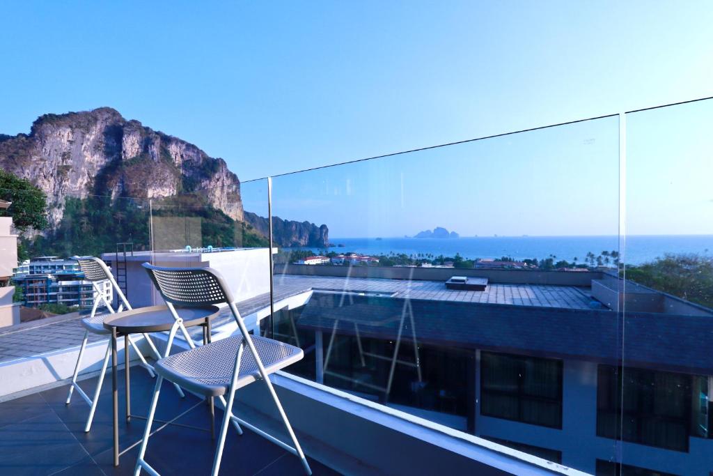 two chairs on a balcony with a view of a mountain at A402-Silk Condo Aonang-Sea view-5 mins walk to beach in Ao Nang Beach