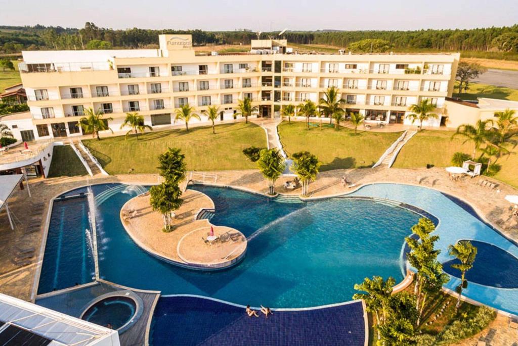 an aerial view of a resort with a swimming pool at Ramada by Wyndham Furnaspark in Formiga