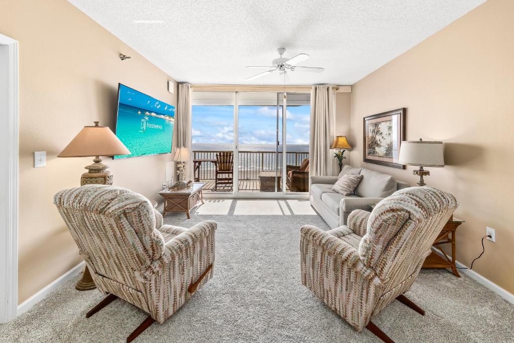 a living room with two chairs and a couch at Beach Club 708D in Gulf Shores