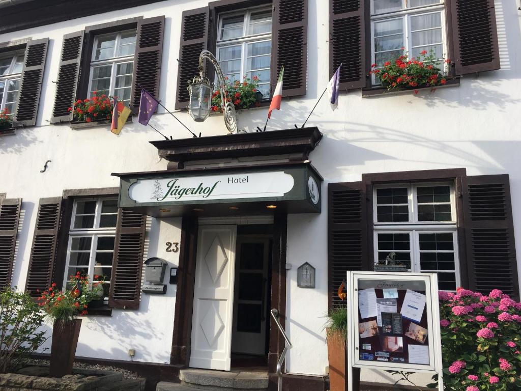 a building with a sign in front of it at Hotel Jägerhof Kettwig in Essen